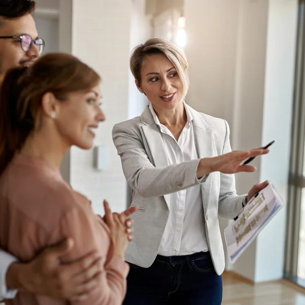 A woman in an office pointing to a document titled "Borrowing to Invest."