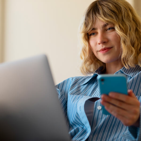 Canadian borrower reviewing digital credit options on a phone and laptop