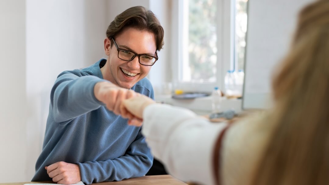 A woman sitting at a desk with an anxious expression, reviewing physical invoices and medical or utility bills while holding her head, illustrating an unexpected expense crisis solved by guaranteed loan approval.